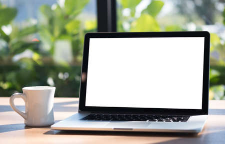 Laptop with blank screen on table. Workspace background new project on laptop computer with blank copy space screen for your advertising text messageの写真素材