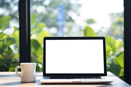 Laptop with blank screen on table. Workspace background new project on laptop computer with blank copy space screen for your advertising text messageの写真素材