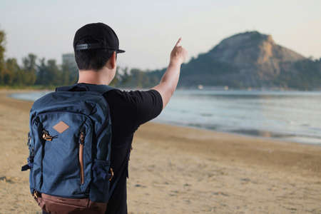 Young man Asian Happy tourists  traveling backpacker Tourist traveler on background viewの写真素材