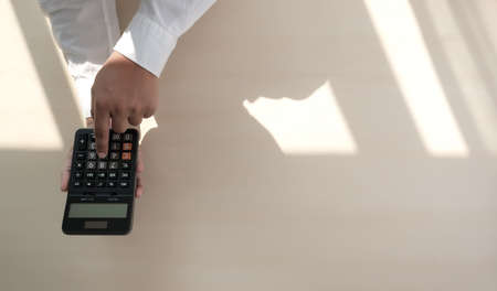 Close up businessman using calculator on documents Unrecognizable finance  use calculate about cost at officeの写真素材