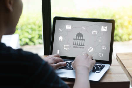 GOVERNANCE and building, Authority Computing Computer Laptop with screen on table Silhouette and...