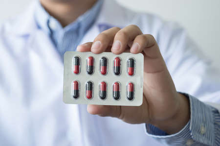 health care  Female pharmacist hold medicine bottle pharmacist holding at drugstoreの写真素材