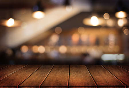 Wooden board empty table  cafe, coffee shop, bar blurred background can be used for display or...