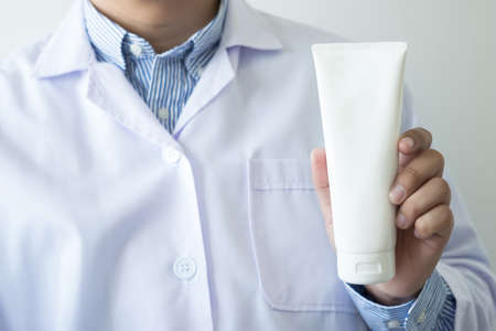 health care  Female pharmacist hold medicine bottle pharmacist holding at drugstoreの写真素材