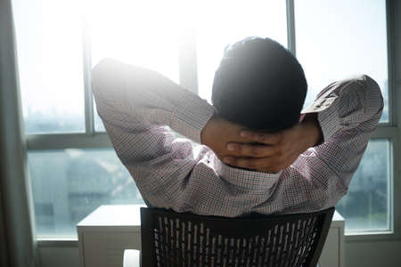 Man smiling  relaxing and enjoying sky  the window  man keeping eyes closed relaxationの写真素材