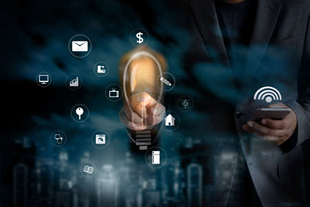 internet iot man  use smartphone internet of things technology (IoT) word diagram as conceptの写真素材