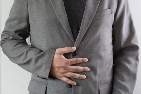 man stomach suffering and having a stomachacheの写真素材