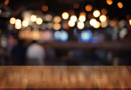 Wooden board empty table  cafe, coffee shop, bar blurred background can be used for display or...