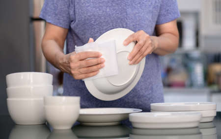 Woman Cleaning product concept wiping dishware cleaner in home and kitchenの写真素材