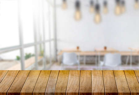 Wooden board empty table  window blurred background can be used for display or montage your products...