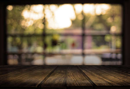 Wooden board empty table  cafe, coffee shop, bar blurred background can be used for display or...
