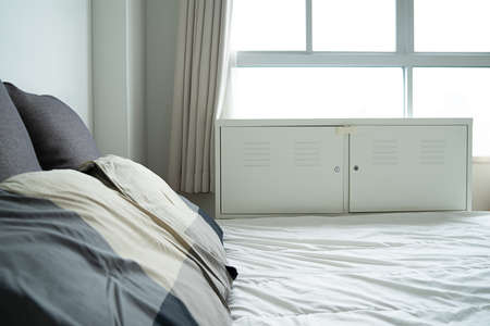 sunlight Bed maid-up with clean white pillows and bed  in the bedroom.の写真素材