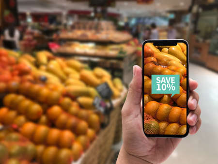 Family in the supermarket use Application of Augmented Reality Supermarket for Discounted or on Sale