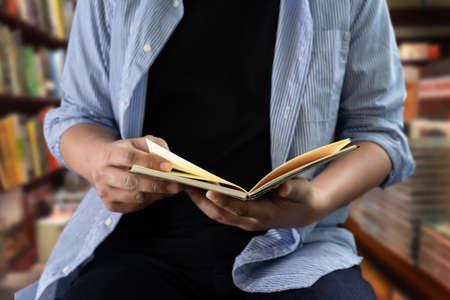 students reading book in library learning and education conceptの写真素材