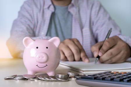 saving for finance accounting Young is saving manage money investmentの写真素材