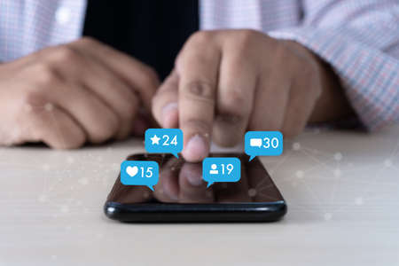 Young man using smart phone Social media and social network Marketing  concept People Connectionの写真素材