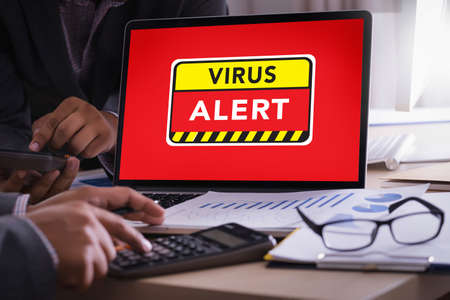 Hacker Protection Concept Man working on laptop Virus Detected Alert Digital Browsing Firewallの写真素材