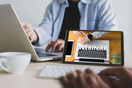 WEBINAR hand on table use E-business Browsing Connection in computer, coffee, Split toneの写真素材