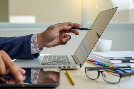 double exposure of business man hand working on laptop computer on wooden desk with social media...