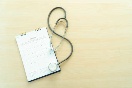 Medical appointment book in the calendar  stethoscope and calendar schedule to check upの写真素材
