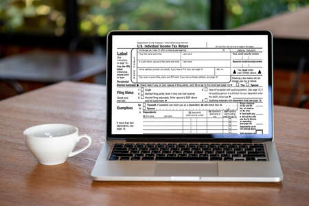 time to tax using calculator and laptop for calaulating finance tax season concept