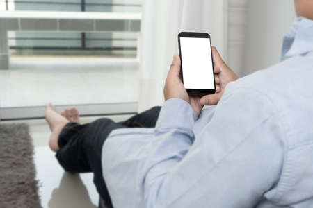 Man hand holding the black smartphone screen mockupの写真素材