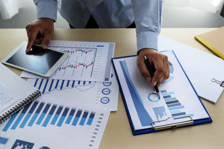 business documents on office  graph financial with social network diagram discussing data analysis...