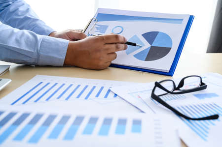 business documents on office  graph financial with social network diagram discussing data analysis...