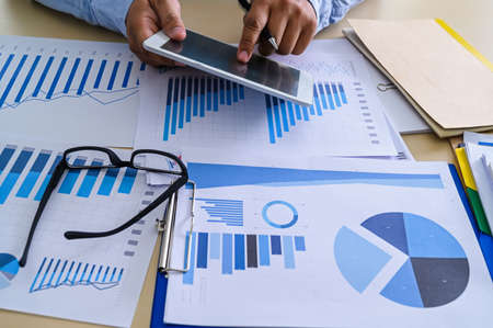 business documents on office  graph financial with social network diagram discussing data analysis...