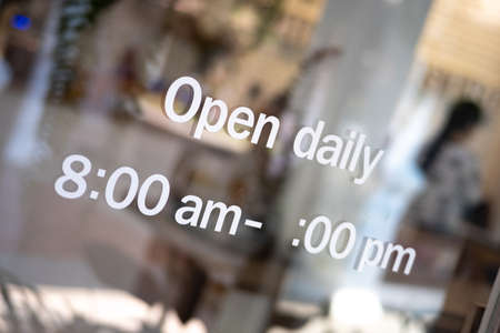 â€˜Openâ€™ on cafe or restaurant hang on door at entrance