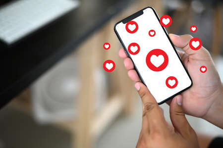 man use Social media,social network  phone message from lovers. Send a message loveの写真素材