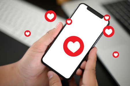 man use Social media,social network  phone message from lovers. Send a message loveの写真素材