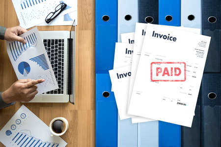 Close-up man work Invoice Bill Paid Payment  At Office Invoice savings, finances bill