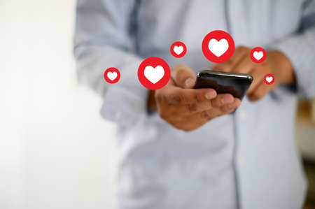 man use Social media,social network  phone message from lovers. Send a message loveの写真素材