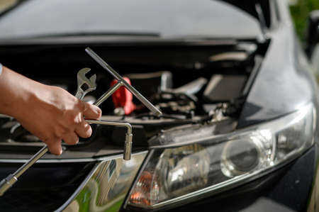 Repair service car Auto mechanic working in garage car mechanic with wrench in garage