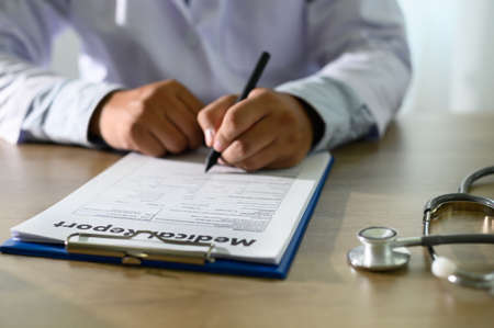 Doctor using computer medical record  medical report or medical certificate database of patient's health careの写真素材