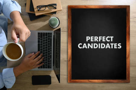 PERFECT CANDIDATES CONCEPT Business team hands at work with financial reports and a laptopの写真素材