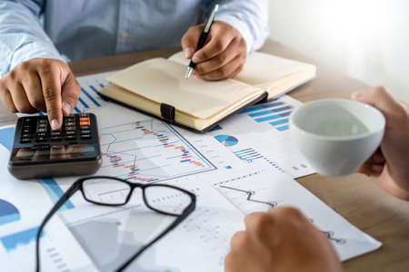 businessman working using a calculator finance accounting concept achievement to balance man...