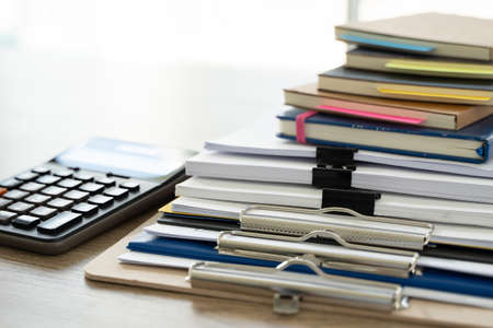 business  man Office employee working contract with documents Stacks of Files paper and law