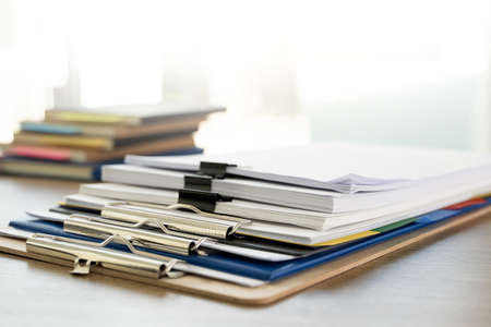 man report stack paper folder close up stacking of office working document with paper legal paperwork on topの写真素材