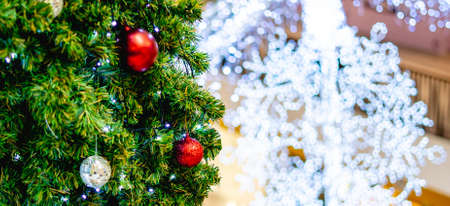 Decorated Christmas tree light on blurred background on holiday merry christmas background tree...