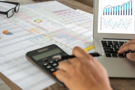 Accounting analysis businessman hand working Strategy Research analyzing financial data and charts