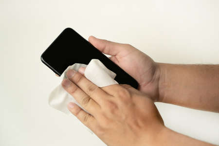 Coronavirus  Cleaning mobile phone screen virus COVID-19 coronavirus preventionの写真素材