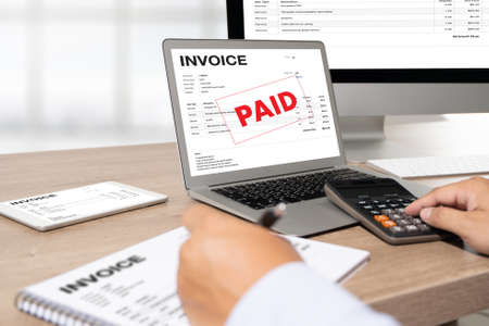 Businessman work Using The Computer Calculating  Invoice In Office Invoice Form and Accountant...