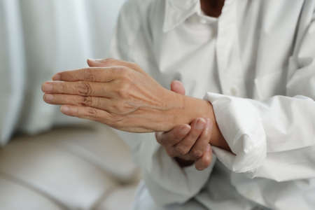 Elderly woman suffering from pain From Rheumatoid Arthritis