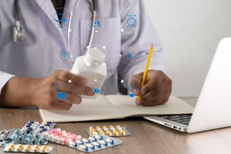 medical doctor writing prescription physician with stethoscope prescribing treatmentの写真素材