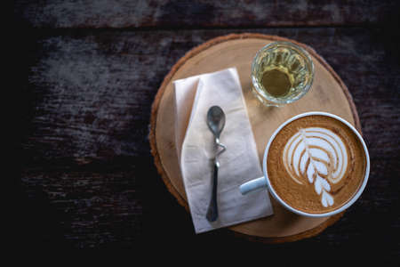 coffee on the wooden table from above. Urban coffee shop  workspace or coffee break in morningの写真素材