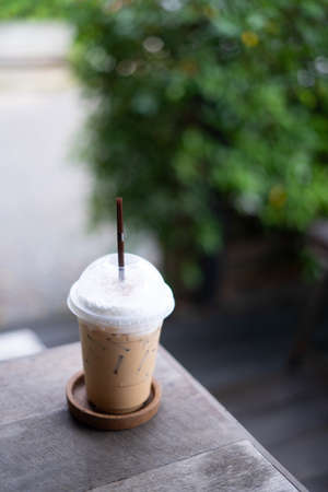 coffee on the wooden table from above. Urban coffee shop workspace or coffee break in morningの写真素材