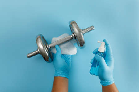 Fitness cleaning gym  virus using  alcohol spray anti virus concept Workout from home stay safe