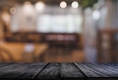 Wood table with blur  in coffee shop cafe For montage product display table copy space cafe...